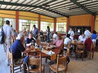 Den grillade maten serveras i en stor sal med en scen mitt p� golvet